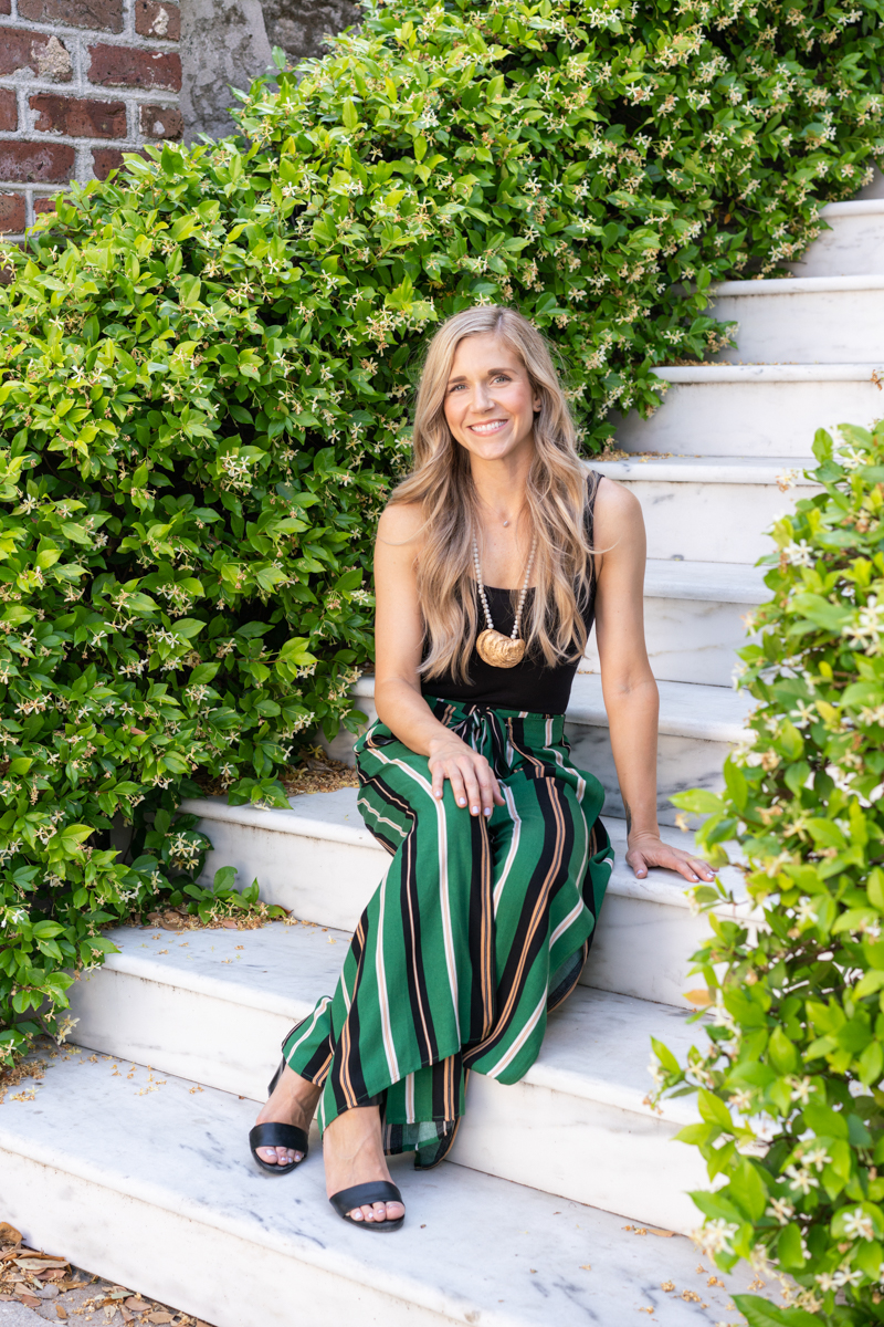 Charleston fashion blogger Lowcountry Lifestyling sitting on white marble stairs