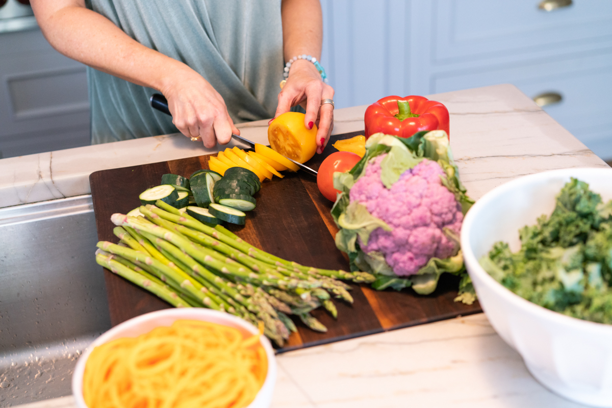 Close up of woman cutting vegetables