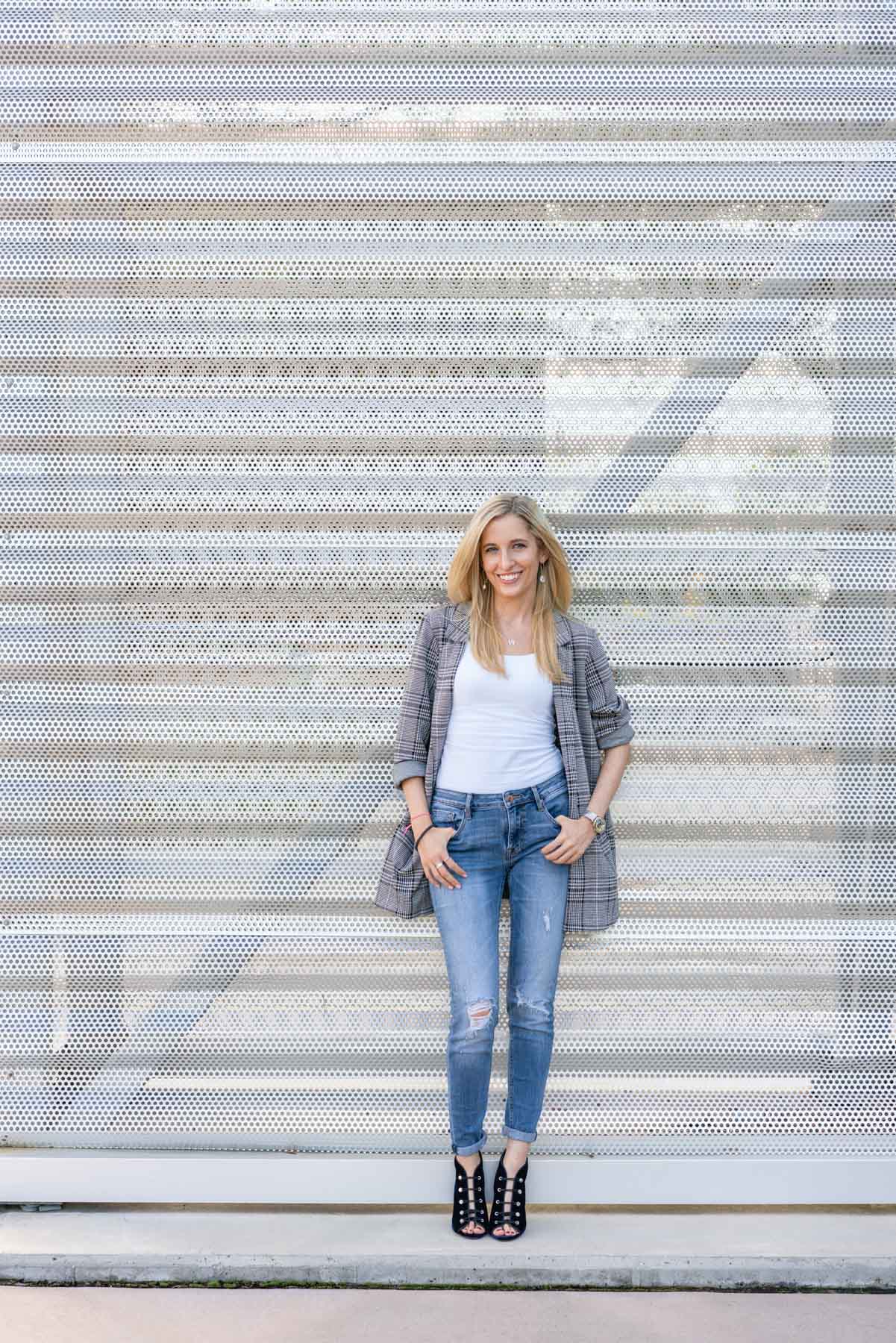 Woman posing in front of a silver metal wall