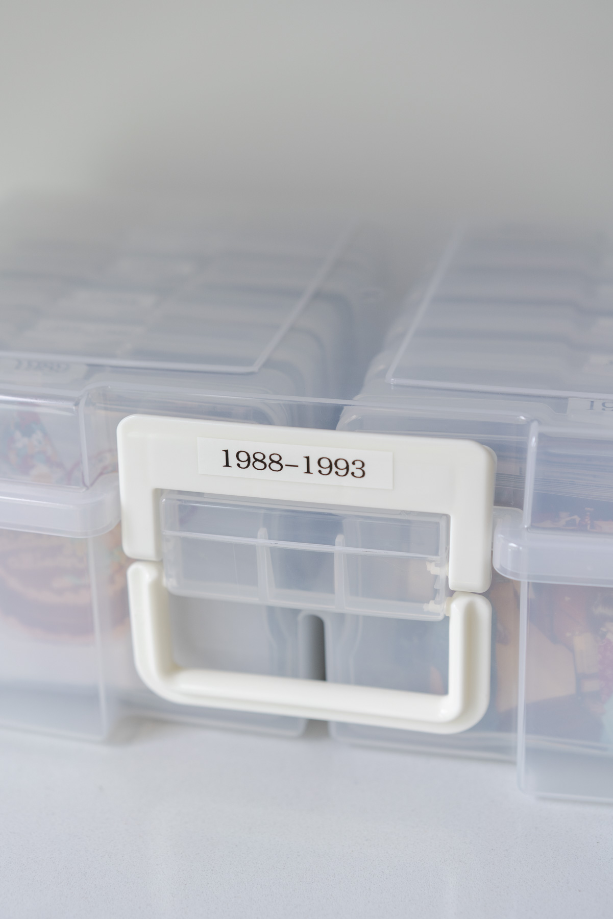 Close up view of the outside of an Iris photo box. The box is labeled 1988-1993.
