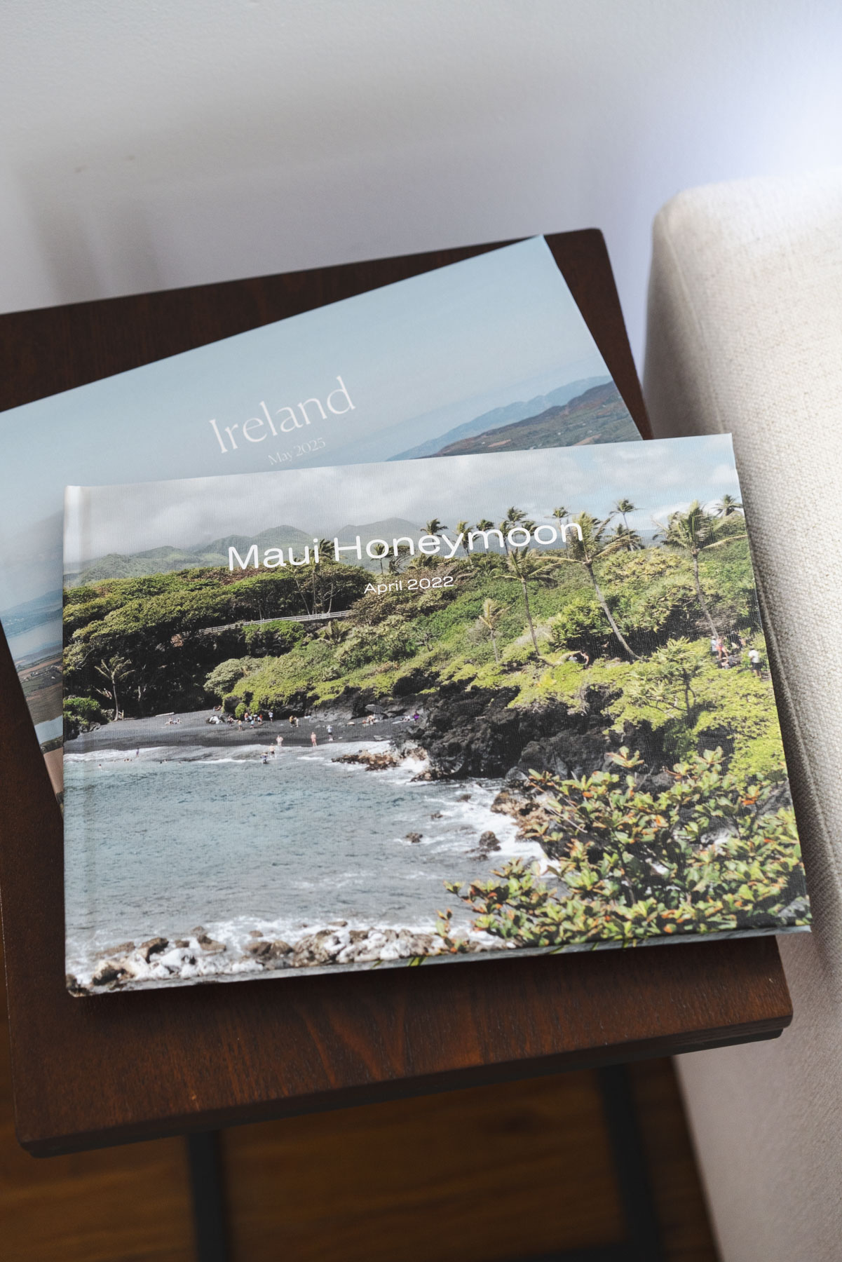 Close up view of the outside of two photo books, one of Maui and one of Ireland. 