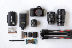 A collection of camera gear on a white background