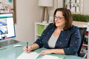 Woman entrepreneur at her desk talking with a client
