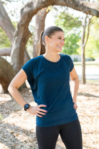 A personal trainer wearing a watch outdoors headshot