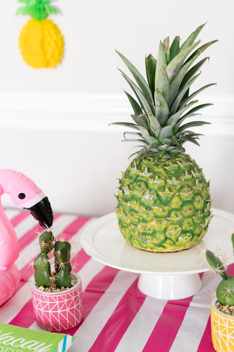 A 3D pineapple cake at a tropical themed party