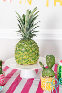 A 3D pineapple cake at a tropical themed party