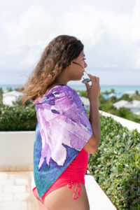 Model wearing a brightly colored towel on a Turks & Caicos beach for a ZAGS lookbook