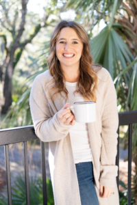 Portrait of a woman holding a coffee mug on her porch