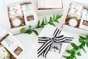 Styled lifestyle photography of custom gift boxes with striped ribbon