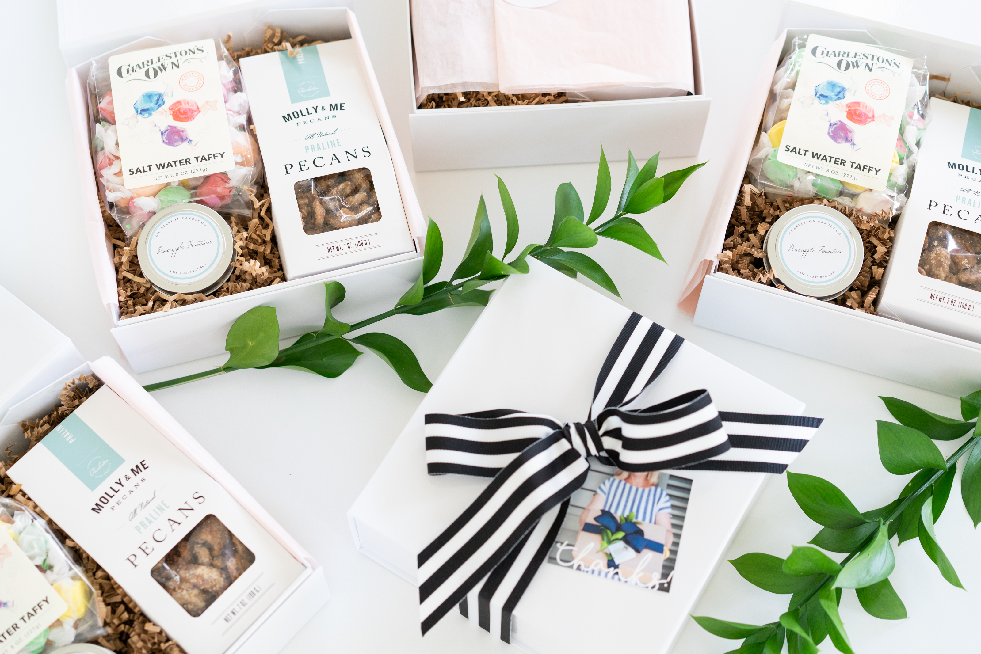 Lifestyle Branding photography of custom gift boxes with striped ribbon