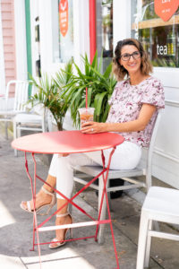 woman sitting outside a juice bar cafe