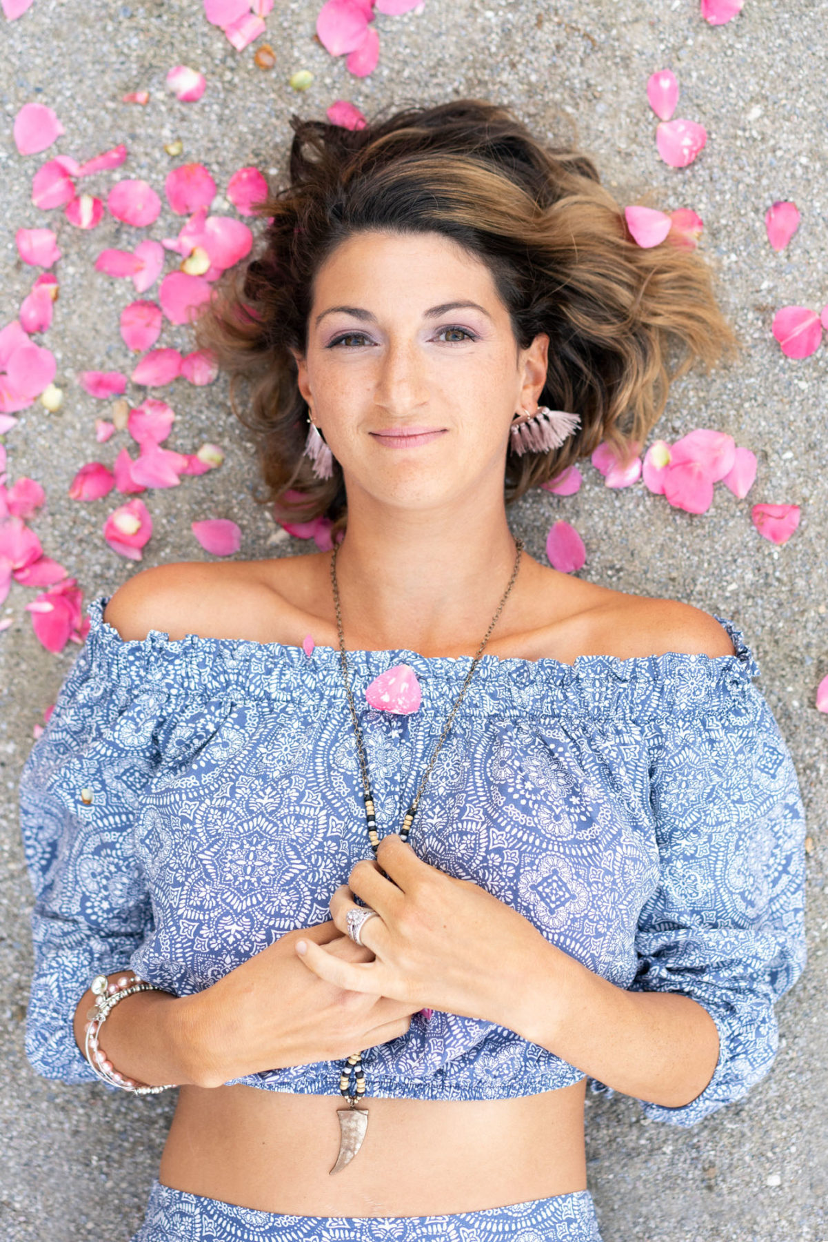 Woman surrounded by pink flower petals