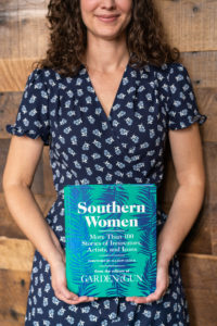 Garden and Gun Deputy Editor Amanda Heckert holding their new book, Southern Women