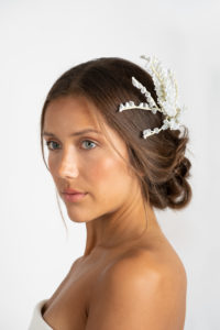 Model on a white background wearing a custom wedding headpiece by Marie Lace Veils