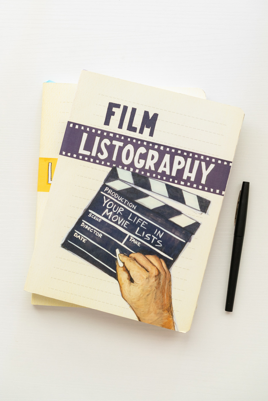 A stack of Listography books featuring Film Listography: Your Life in Movie Lists