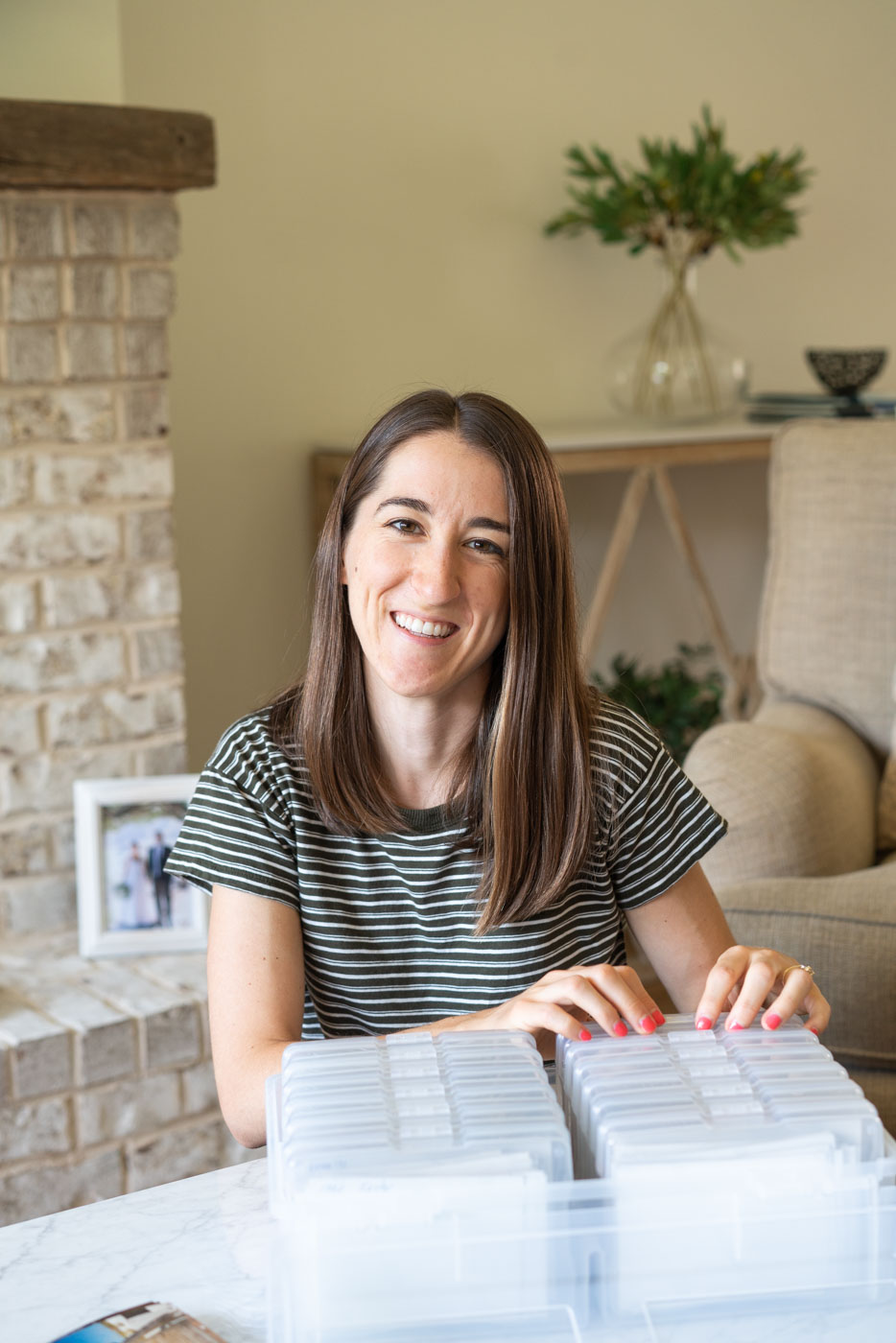 Woman organizing old family photos with a clear plastic photo case