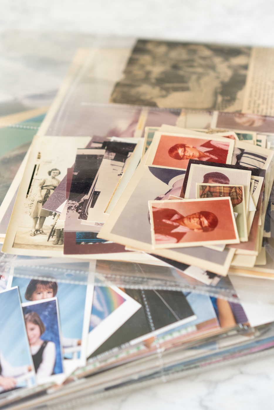 A collection of old family photos in clear plastic photo protective sleeves