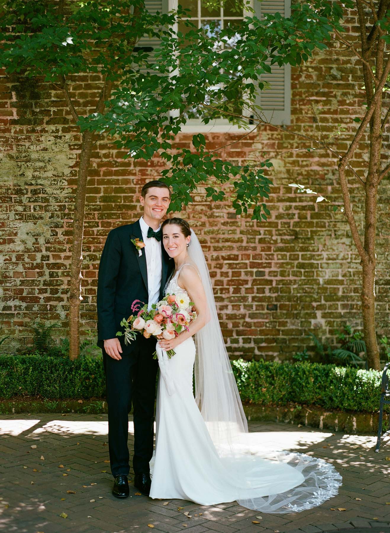 Bride Abby Murphy and her groom Hunter pose together at Zero George hotel in Charleston, SC