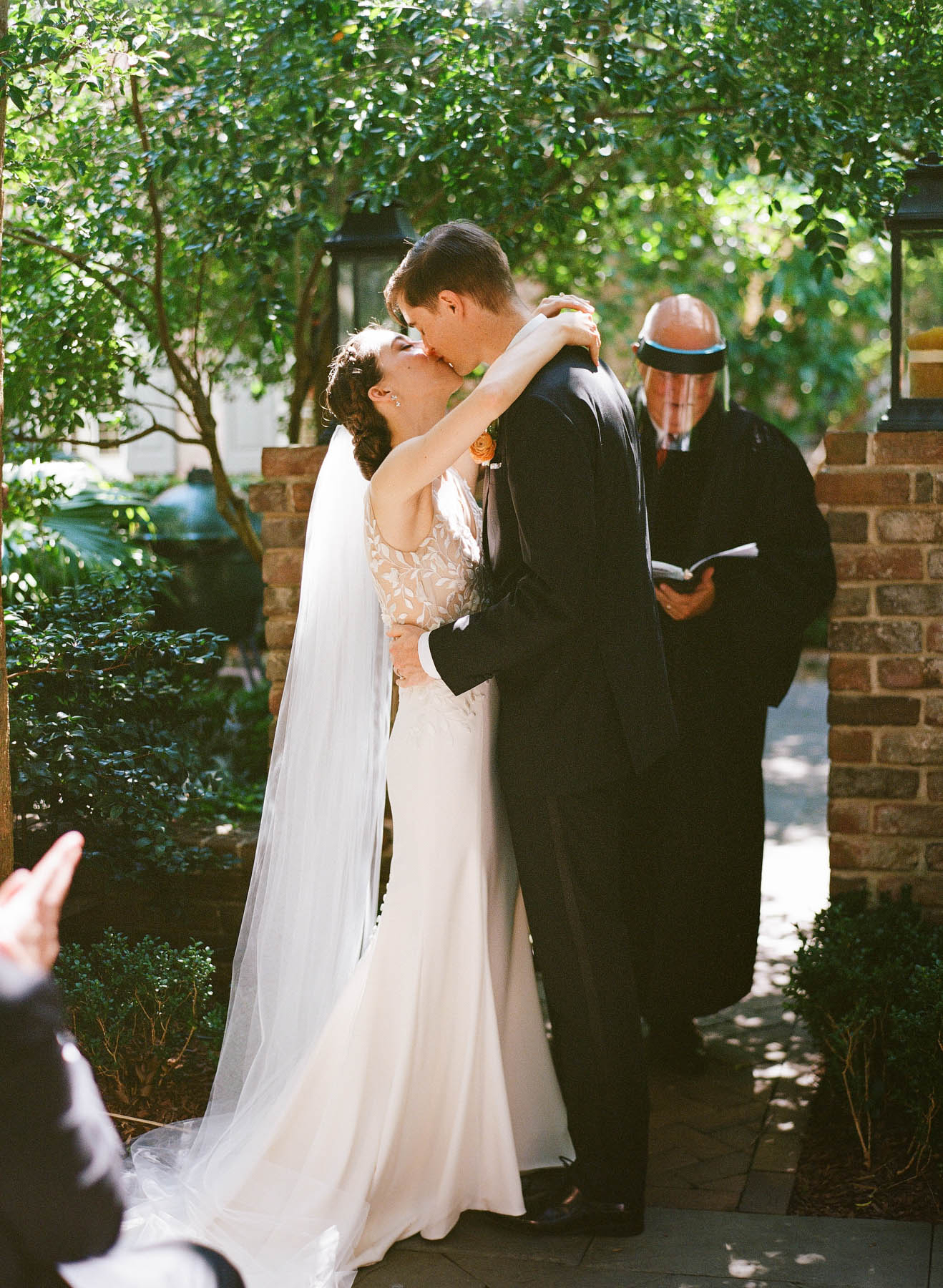 A bride and groom kiss during their intimate wedding ceremony at Zero George hotel in Charleston, SC 