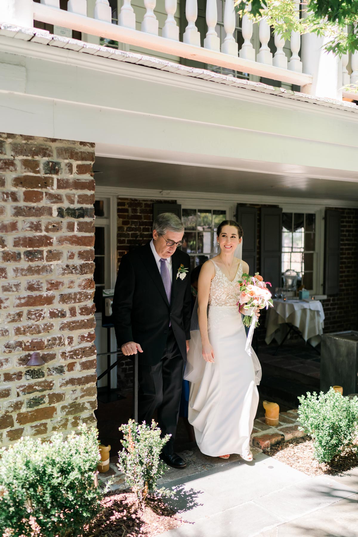 A bride and her father preparing to walk down the aisle