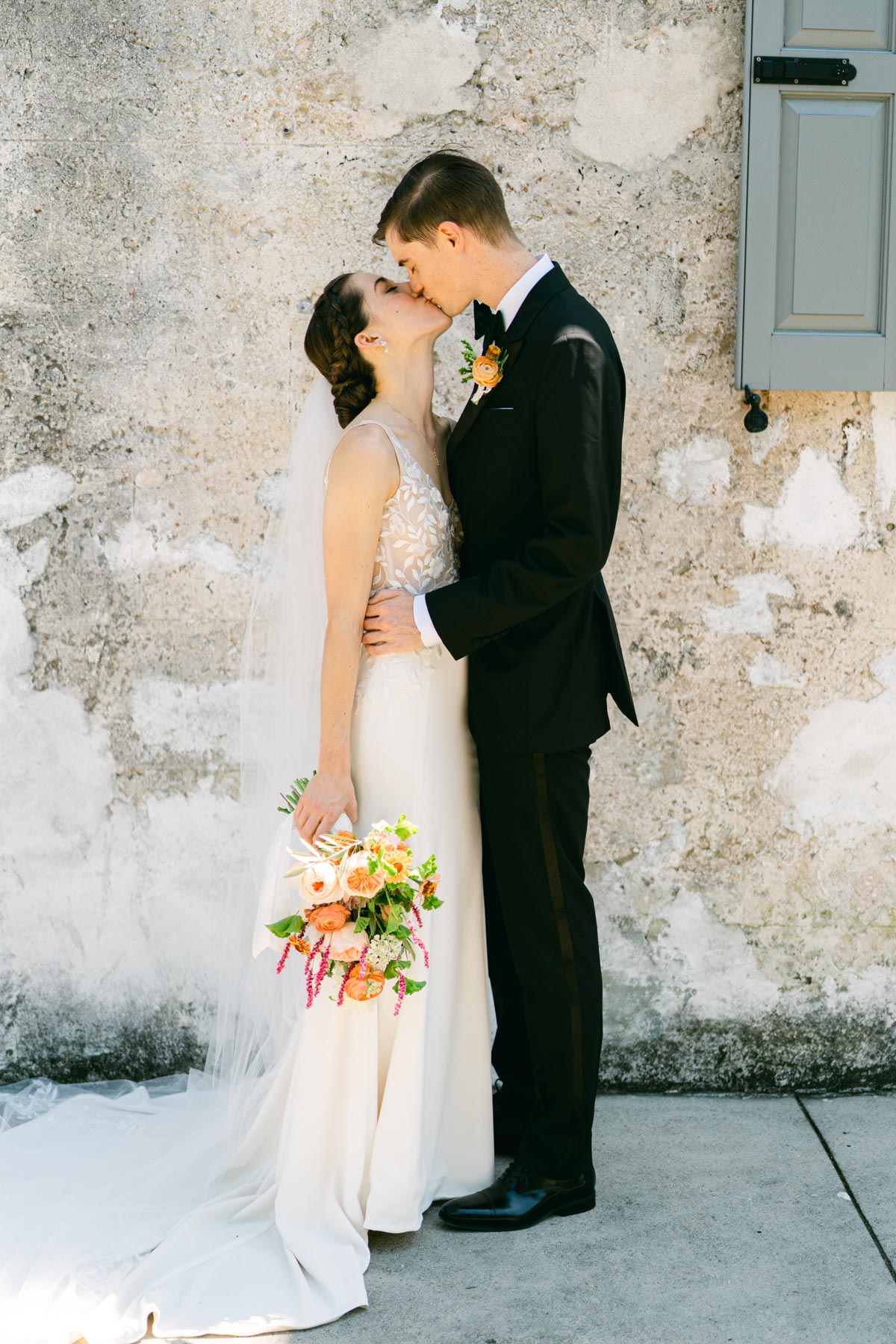 A bride and groom kiss at Zero George hotel in Charleston, SC
