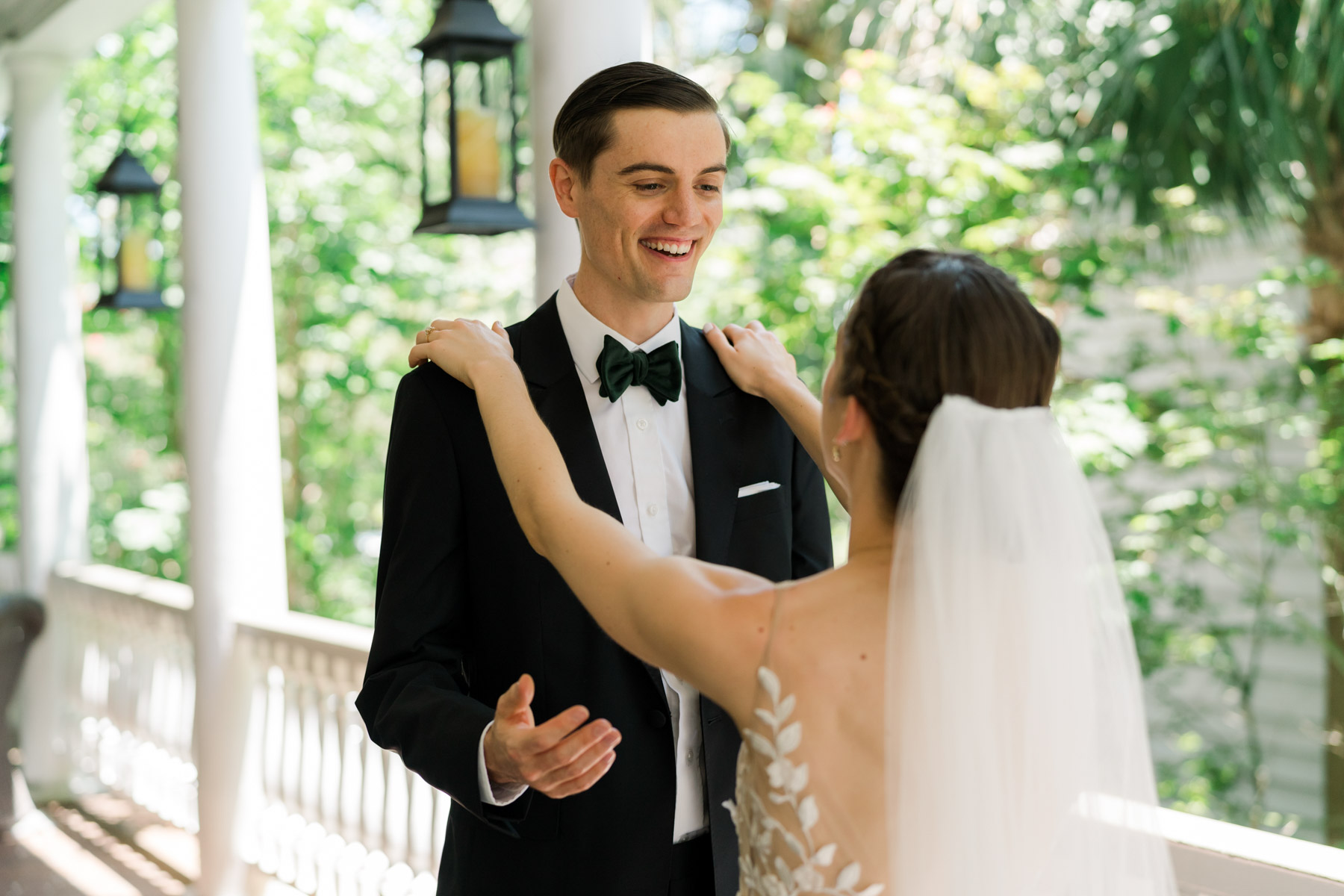 A groom smiles at his bride during their first look