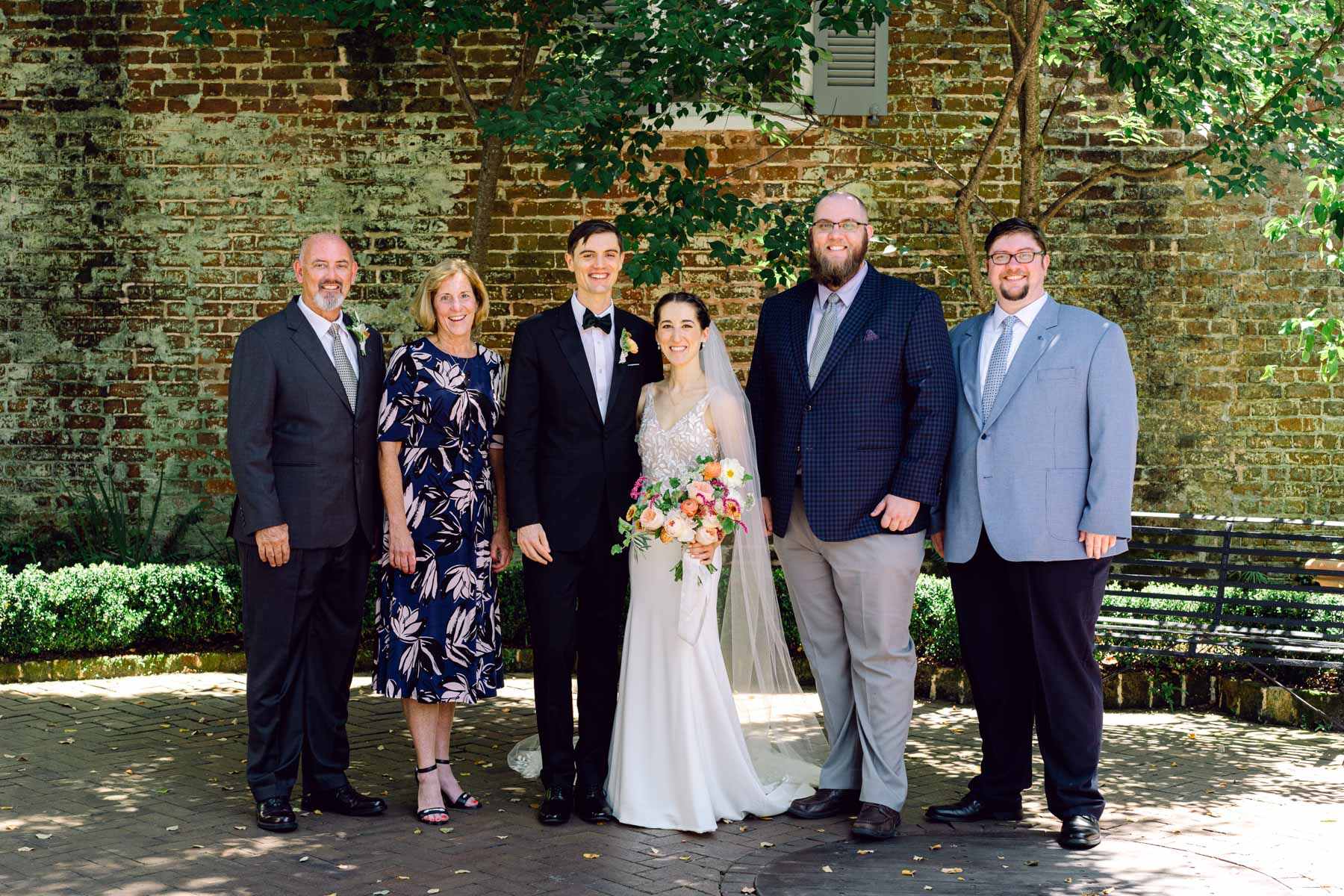 A family wedding portrait with the bride and groom