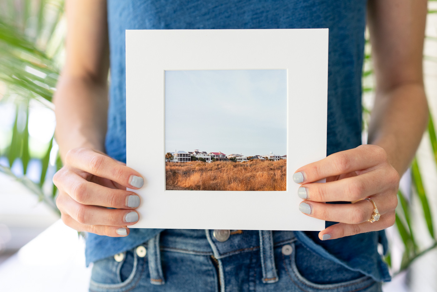 Woman holding an unframed matted film photography print of Sullivan's Island Beach, South Carolina