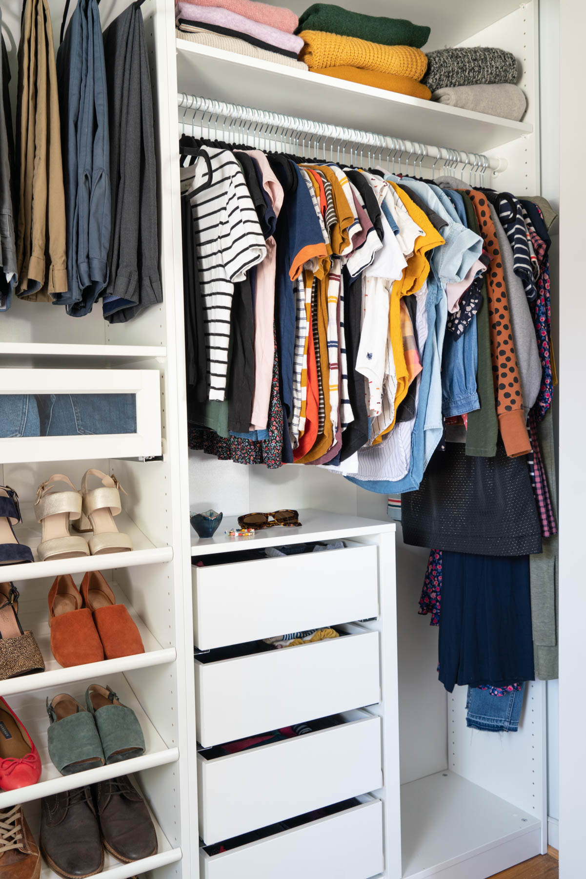 A master closet designed with IKEA PAX wardrobe system