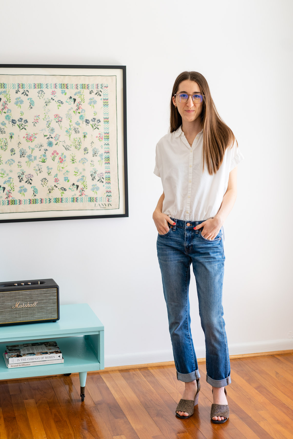 Woman modeling Madewell's Slim Boyfriend Jeans jeans with a white button up shirt tied at the waist
