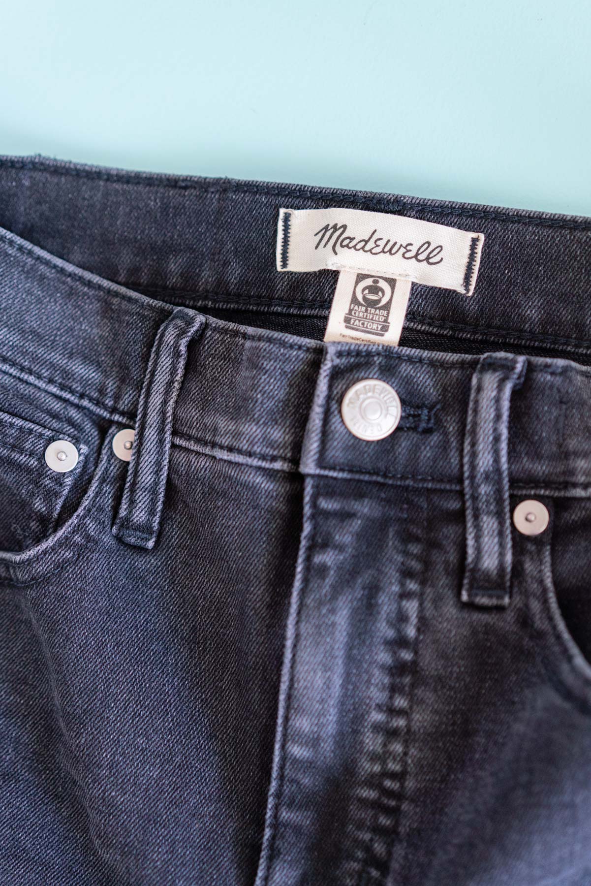 A close-up of Madewell's Classic Straight jeans and the Fair Trade tag inside of them