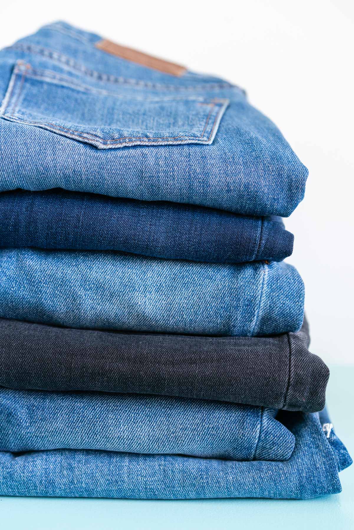 A pile of 6 pairs of Madewell denim jeans in various washes