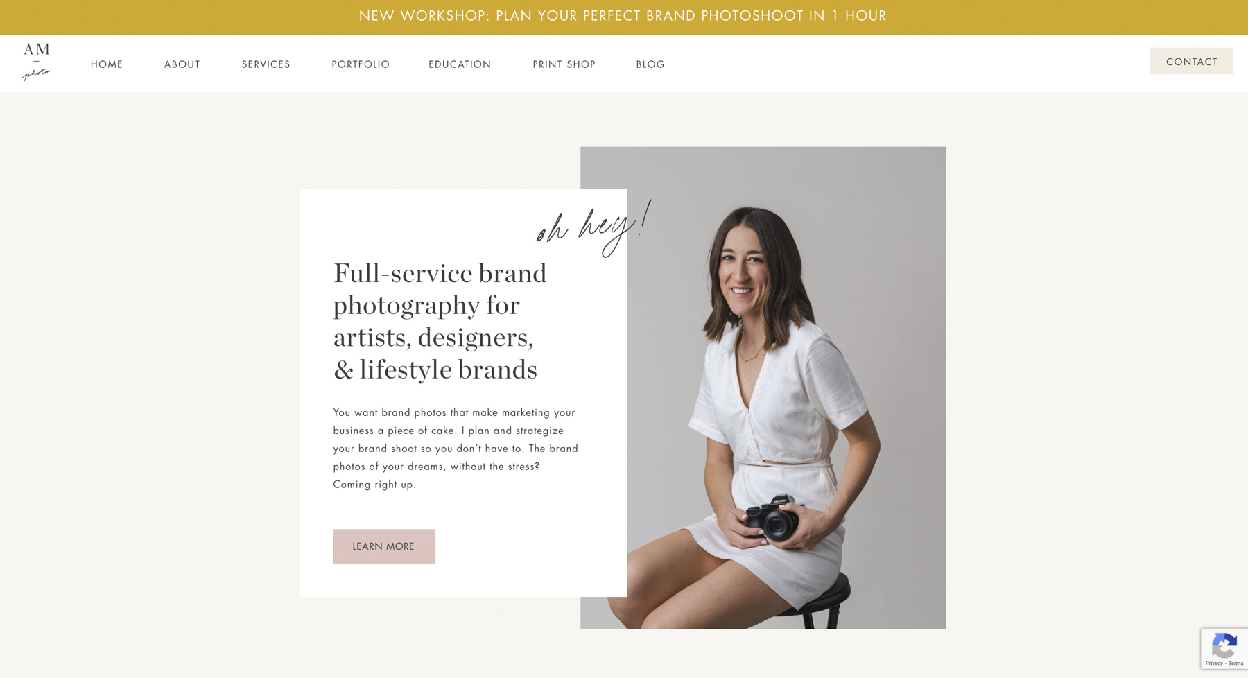 Screenshot of the home page of Abby Murphy's website. You can see Abby Murphy sitting on a stool with a camera in her hand. 