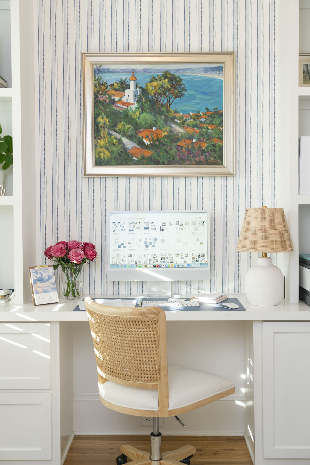 pic of desk with lamp and picture above the desk