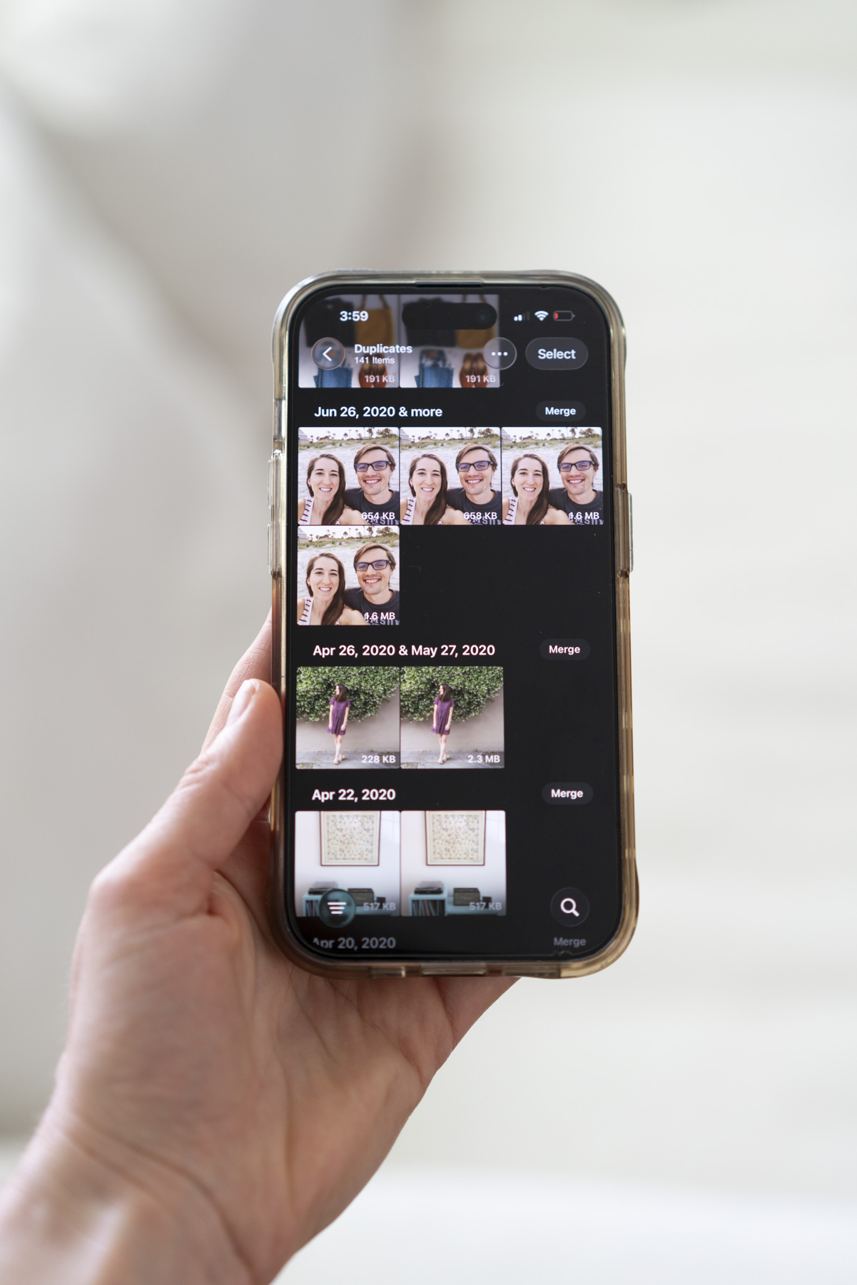 iPhone Photos Duplicates page showing merge and select options